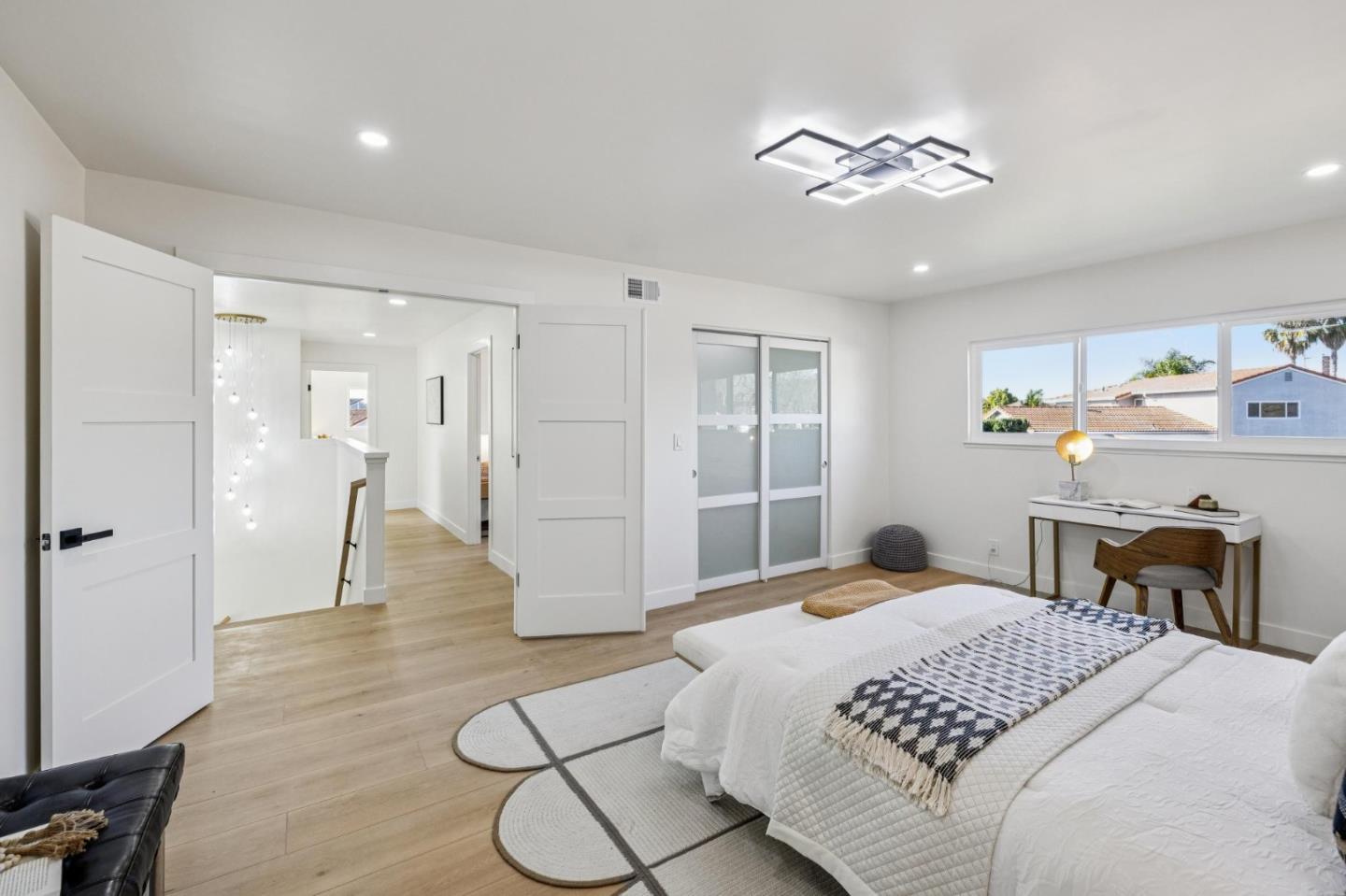 2043 Shellback Place San Jose, CA 95133 - Photo 24 of 52 a bedroom with a bed and a chandelier