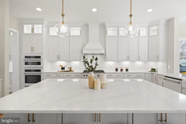 a dining hall with stainless steel appliances kitchen island a table and chairs