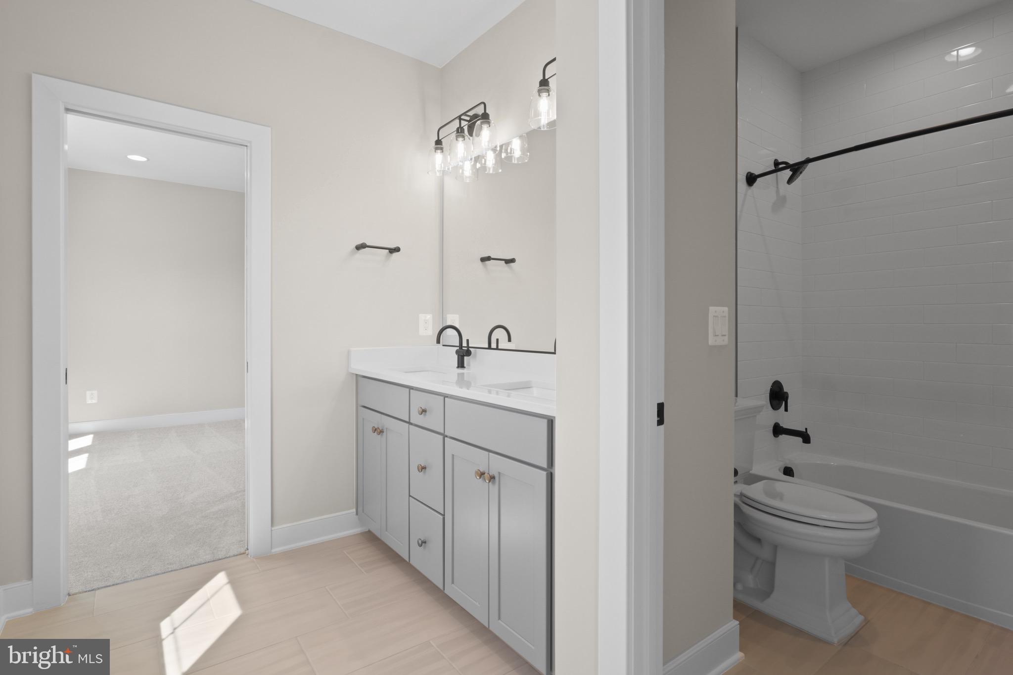 1749 Beulah Road Vienna, VA 22182 - Photo 60 of 88 a spacious bathroom with a double vanity sink a toilet and shower