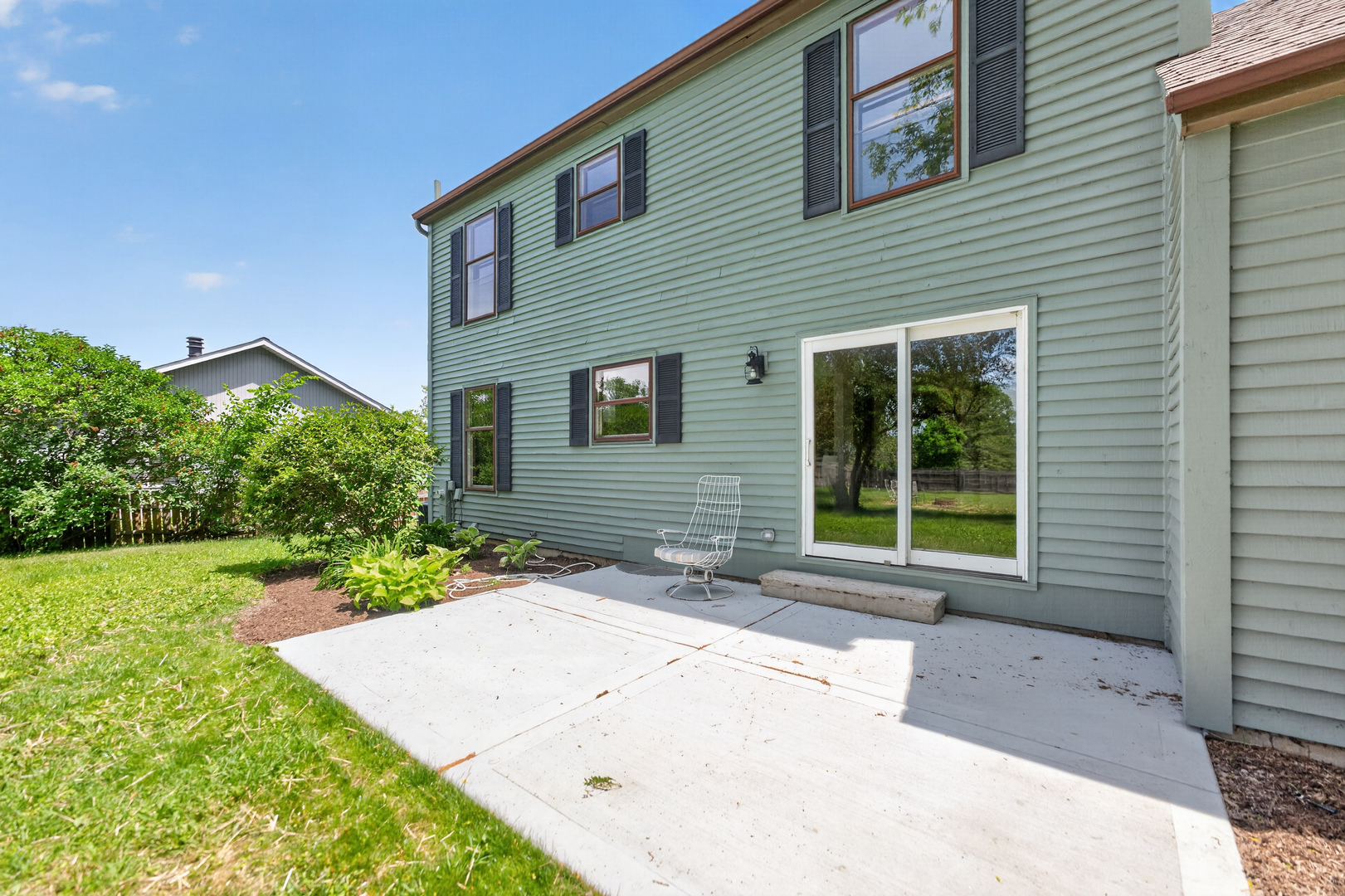 9 Jennifer Lane DeKalb, IL 60115 - Photo 10 of 16 a front view of a house with a yard and potted plants