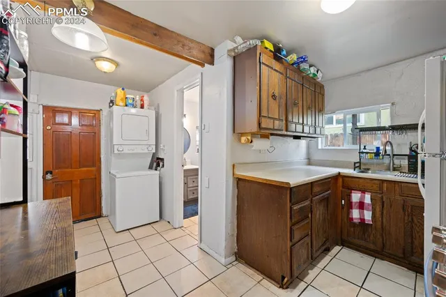 a kitchen with a sink and a refrigerator