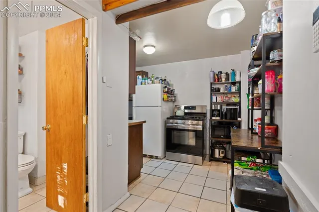a kitchen with stainless steel appliances granite countertop a refrigerator and a stove