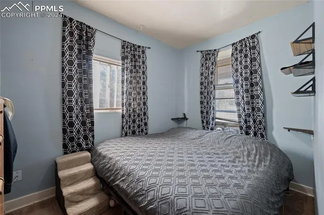 a bedroom with a bed and a chair