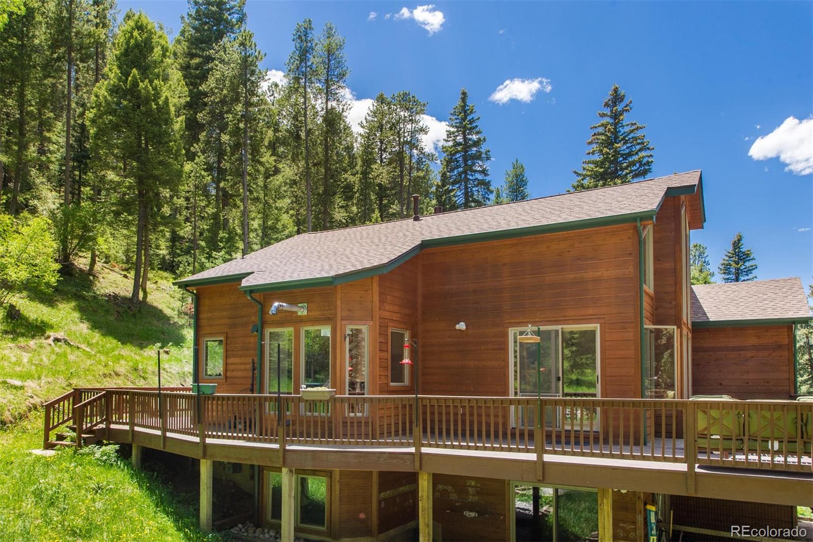 23994 Running Deer Road Conifer, CO 80433 - Photo 31 of 34 a view of a house with a balcony