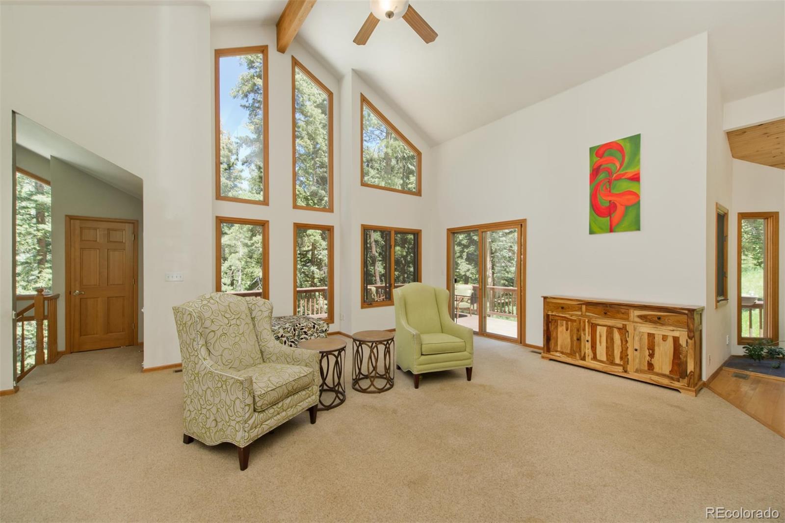 23994 Running Deer Road Conifer, CO 80433 - Photo 4 of 34 a living room with furniture and a large window