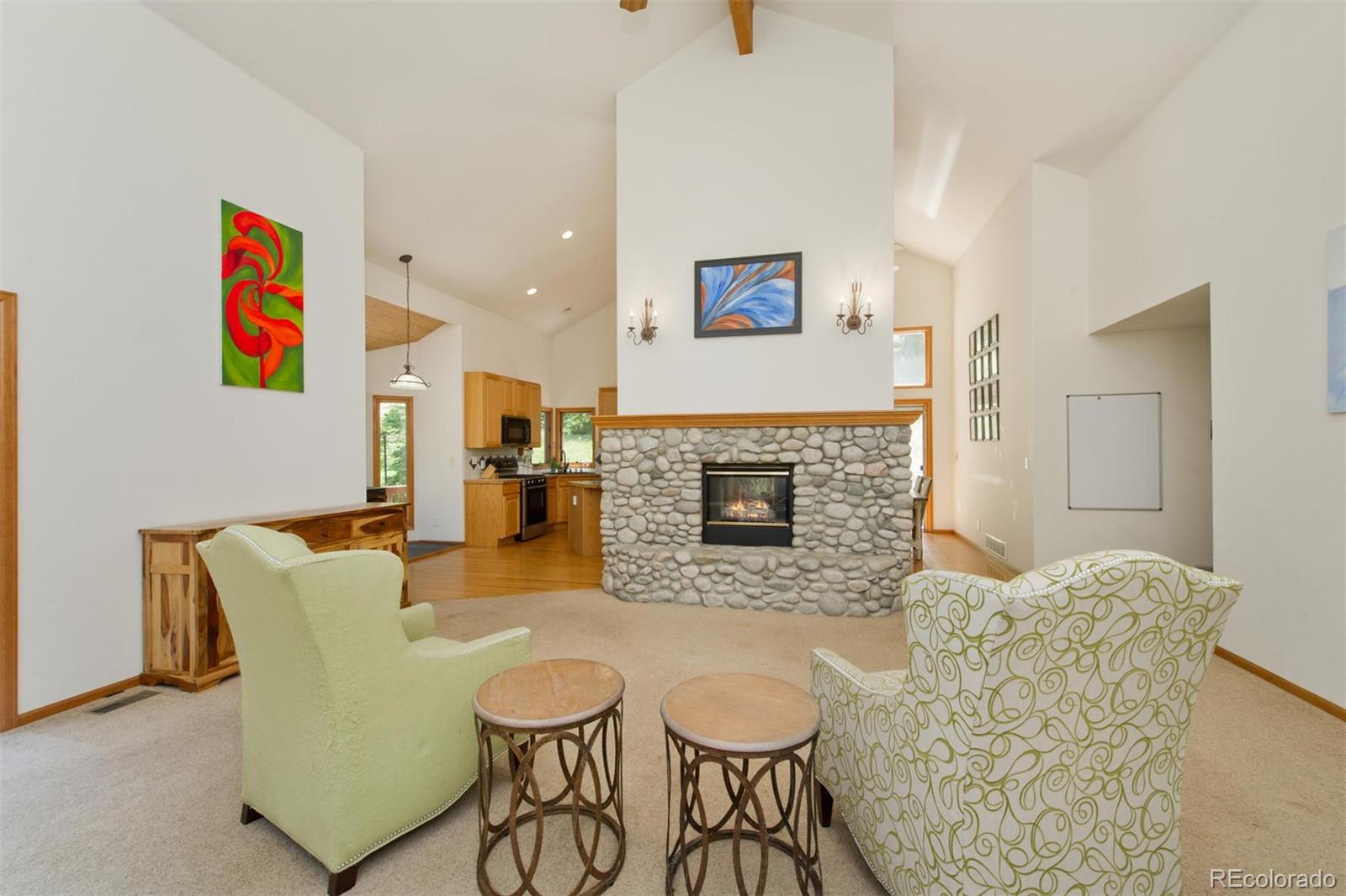 23994 Running Deer Road Conifer, CO 80433 - Photo 5 of 34 a living room with furniture and a fireplace