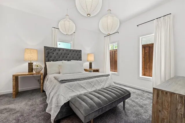 a bedroom with bed and wooden floor