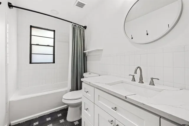 a bathroom with a sink a toilet and a mirror