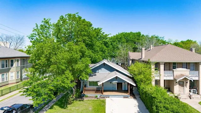 a front view of a house with a yard garage and outdoor seating