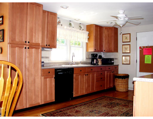 80 South Meadow Road Lancaster, MA 01523 - Photo 3 of 17 a kitchen with stainless steel appliances granite countertop a refrigerator a sink and wooden cabinets