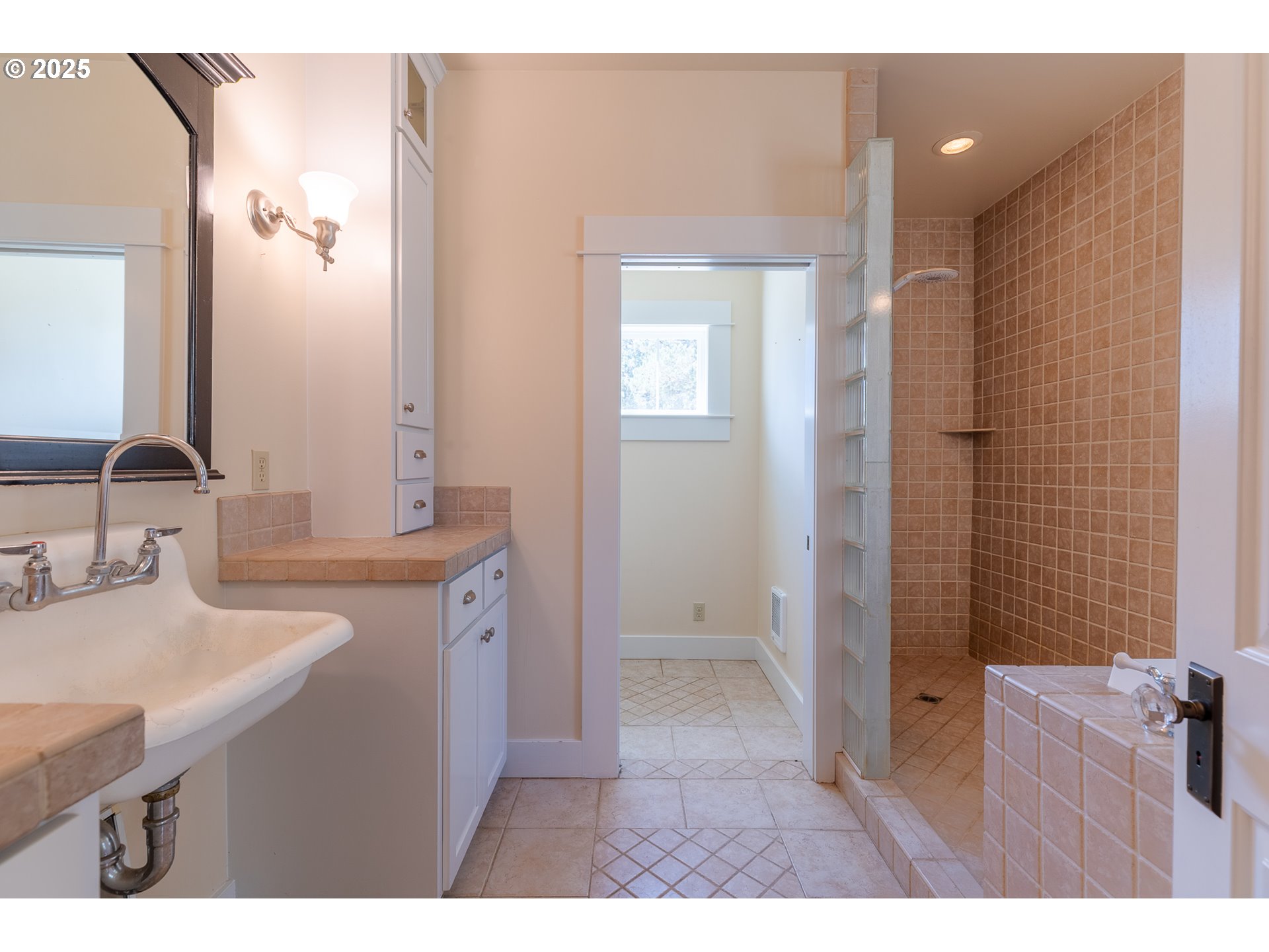 7140 Jake Road Klamath Falls, OR 97601 - Photo 15 of 47 a bathroom with a granite countertop sink a mirror and a shower