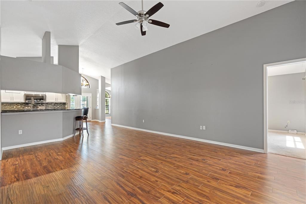 9224 Halberg Drive Hudson, FL 34669 - Photo 11 of 31 a view of empty room with wooden floor and window