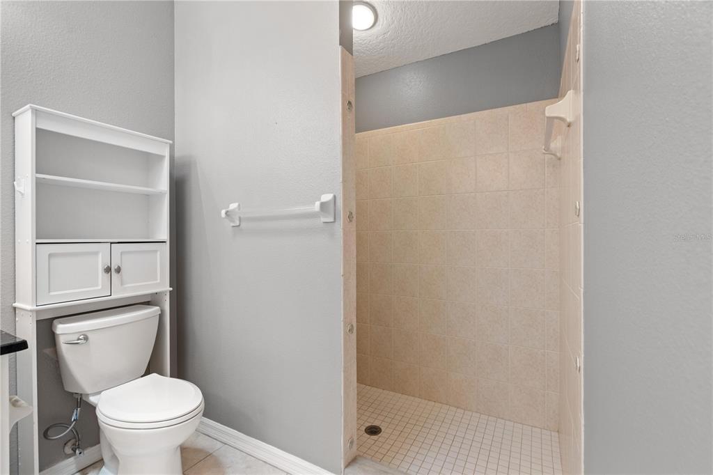 9224 Halberg Drive Hudson, FL 34669 - Photo 15 of 31 a bathroom with a toilet and a shower