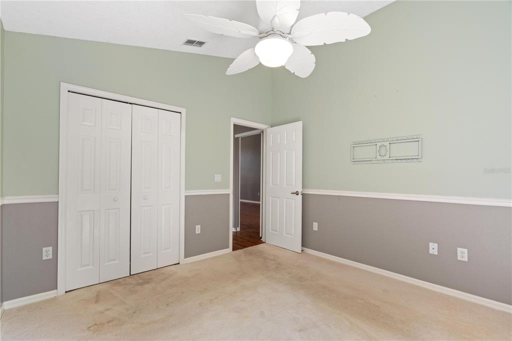 9224 Halberg Drive Hudson, FL 34669 - Photo 17 of 31 an empty room with closet and a chandelier fan