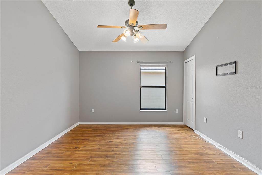 9224 Halberg Drive Hudson, FL 34669 - Photo 18 of 31 a view of empty room with wooden floor and fan