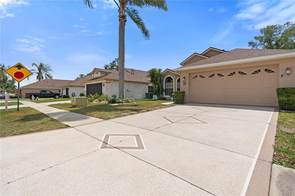 9224 Halberg Drive Hudson, FL 34669 - Photo 2 of 31 a view of a white house with a yard and potted plants