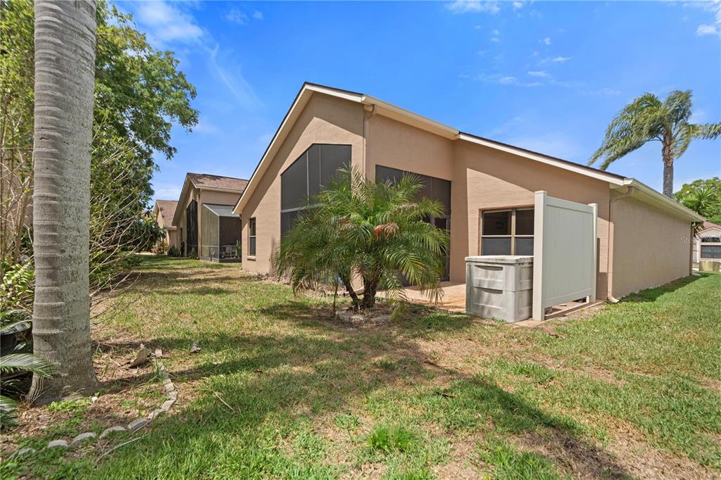 9224 Halberg Drive Hudson, FL 34669 - Photo 28 of 31 a view of a house with backyard and a tree