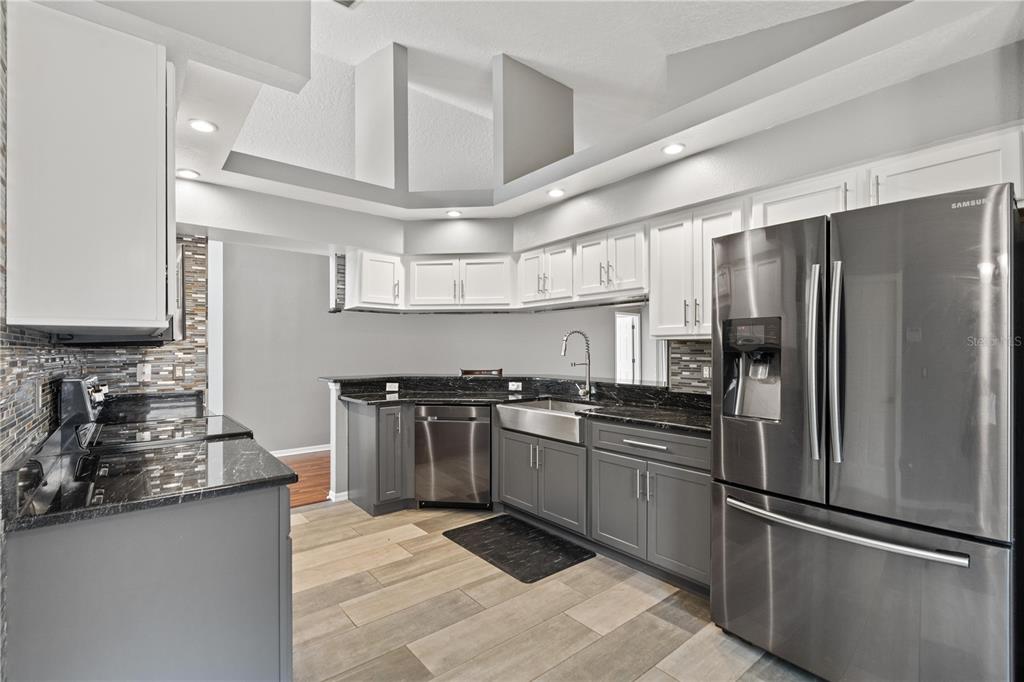 9224 Halberg Drive Hudson, FL 34669 - Photo 4 of 31 a kitchen with stainless steel appliances granite countertop a refrigerator and a stove