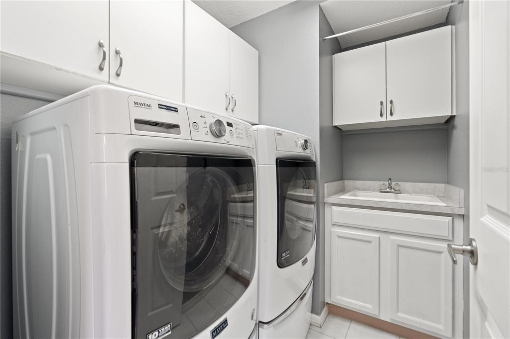9224 Halberg Drive Hudson, FL 34669 - Photo 7 of 31 a utility room with dryer and washer