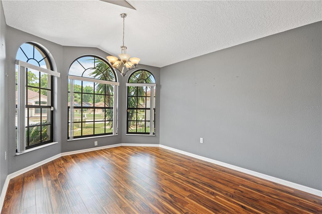 9224 Halberg Drive Hudson, FL 34669 - Photo 8 of 31 a view of an empty room with a window and wooden floor