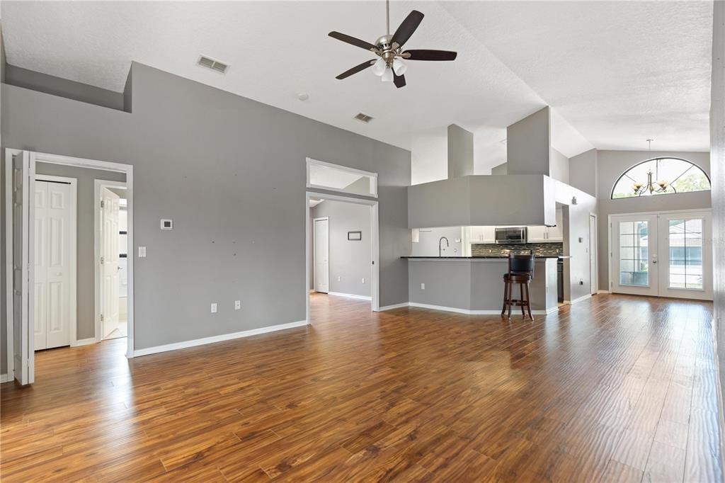 9224 Halberg Drive Hudson, FL 34669 - Photo 9 of 31 a view of a kitchen with a stove cabinets a ceiling fan and wooden floor