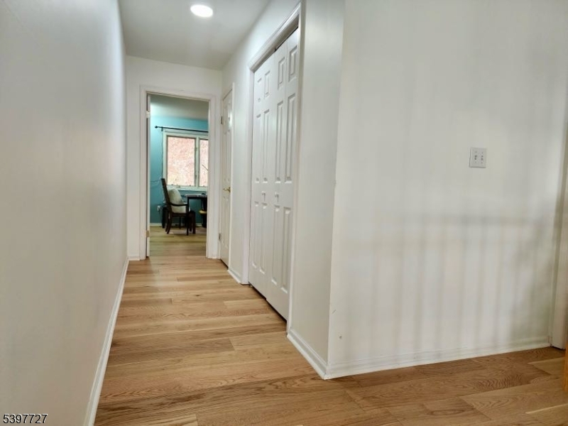 48 Edgefield Drive Morris Plains, NJ 07950 - Photo 12 of 21 a view of a hallway with wooden floor and a bathroom