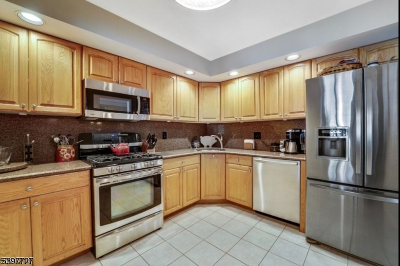 48 Edgefield Drive Morris Plains, NJ 07950 - Photo 6 of 21 a kitchen with stainless steel appliances granite countertop a stove a sink dishwasher a refrigerator and a microwave