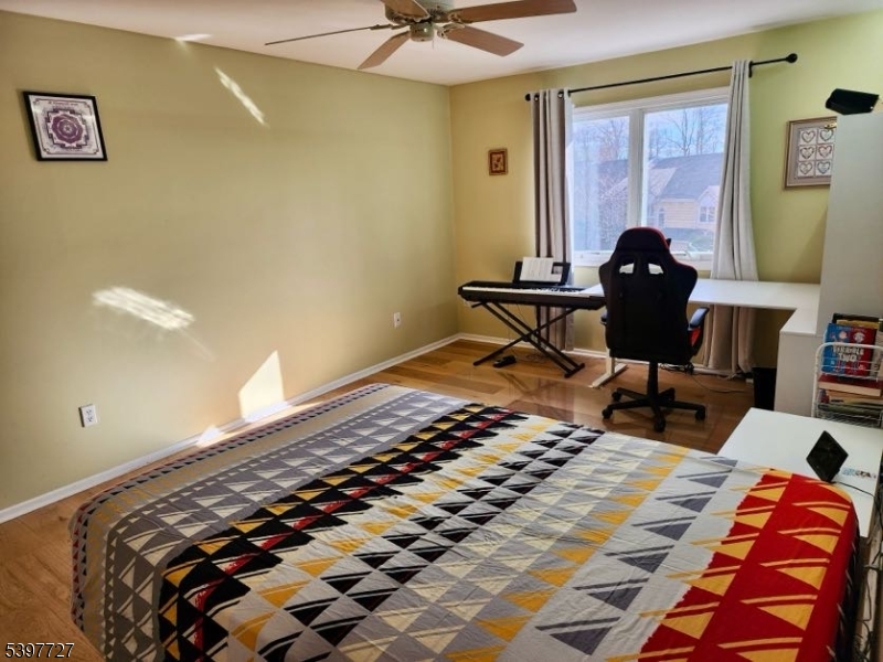 48 Edgefield Drive Morris Plains, NJ 07950 - Photo 7 of 21 a bedroom with a bed and wooden floor