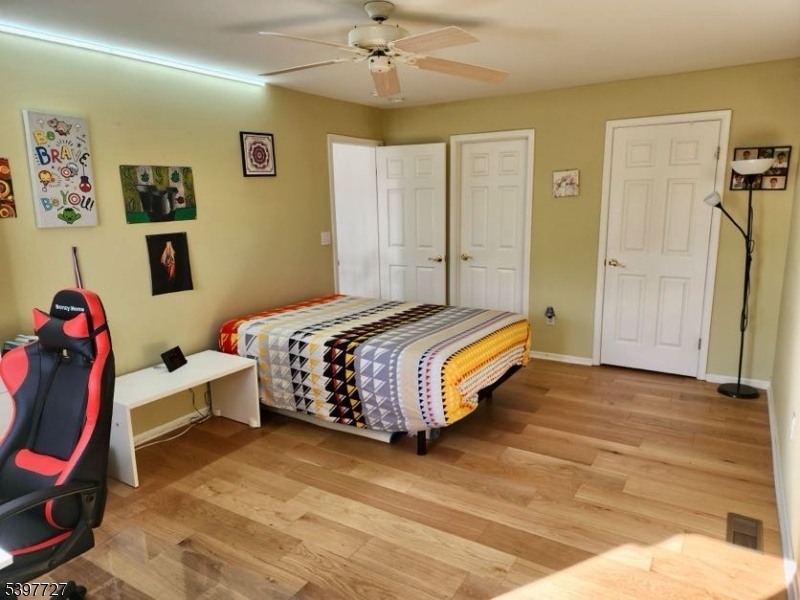 48 Edgefield Drive Morris Plains, NJ 07950 - Photo 8 of 21 a bedroom with a bed and a chandelier