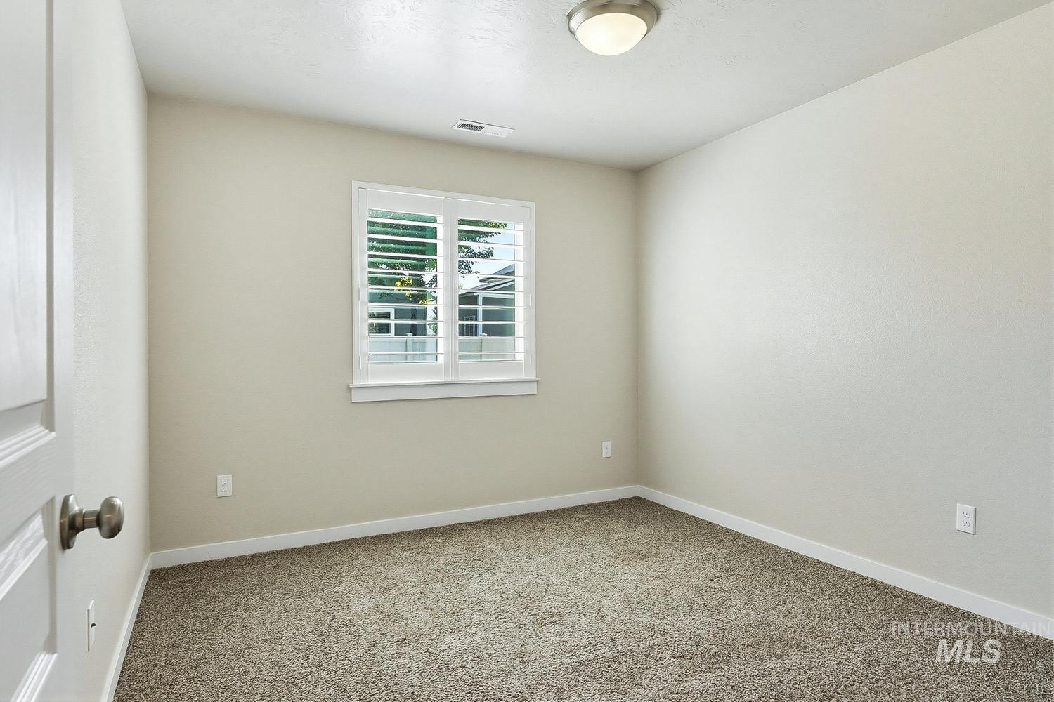 846 North Hidden View Way Star, ID 83669 - Photo 21 of 49 Bedroom featuring neutral wall paint, textured carpet flooring, and a window with plantation shutters
