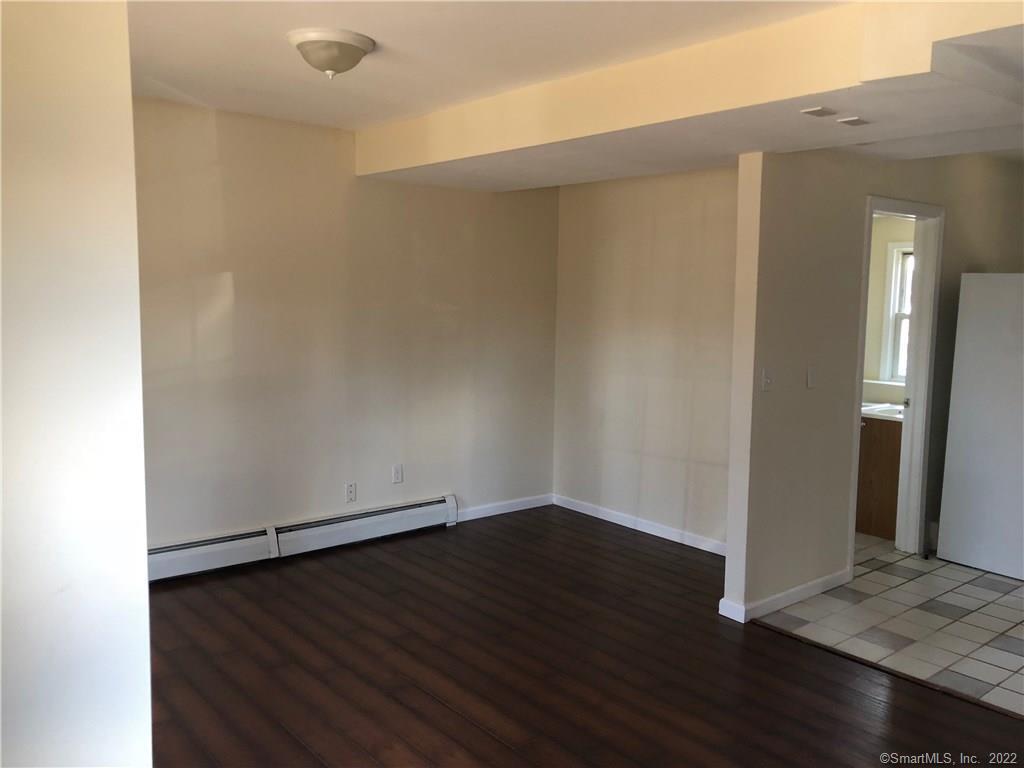 155 Dividend Road, Unit 1 Rocky Hill, CT 06067 - Photo 5 of 13 LIVING ROOM WITH LAMINATE FLOORING OPEN TO KITCHEN