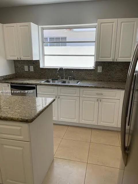 2710 Southwest 31st Avenue Miami, FL 33133 - Photo 12 of 29 a kitchen with granite countertop a sink a stove and cabinets