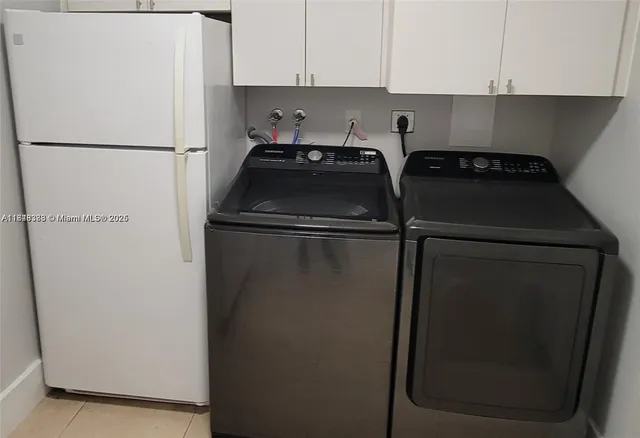 a white refrigerator freezer and a stove sitting inside of a kitchen