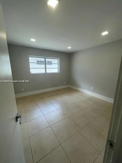 2710 Southwest 31st Avenue Miami, FL 33133 - Photo 17 of 29 an empty room with windows and entrance