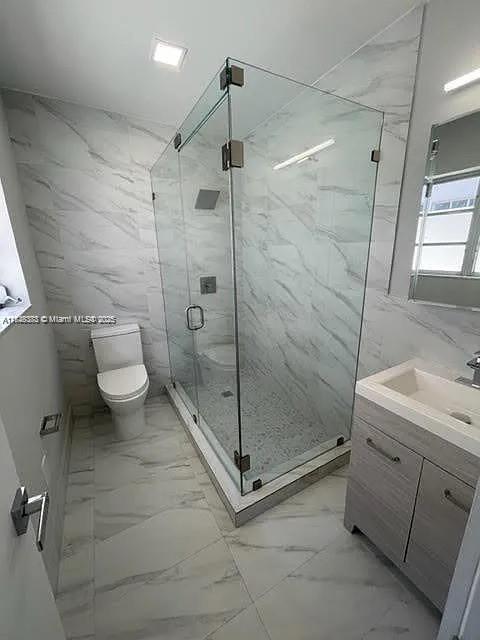 2710 Southwest 31st Avenue Miami, FL 33133 - Photo 19 of 29 a bathroom with a shower and a toilet sink