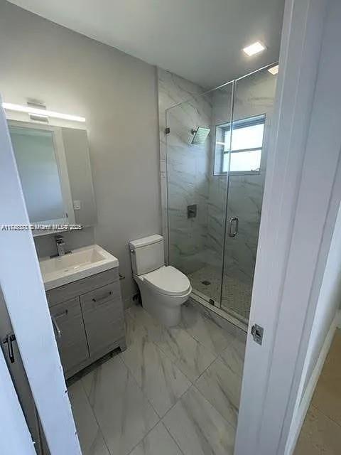 2710 Southwest 31st Avenue Miami, FL 33133 - Photo 21 of 29 a bathroom with a double vanity sink toilet mirror and shower