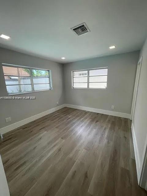 2710 Southwest 31st Avenue Miami, FL 33133 - Photo 22 of 29 an empty room with wooden floor and windows