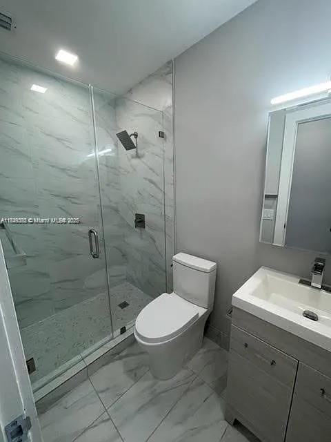 2710 Southwest 31st Avenue Miami, FL 33133 - Photo 24 of 29 a bathroom with a toilet a sink a mirror and shower