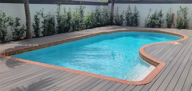 a view of a wooden deck with a backyard