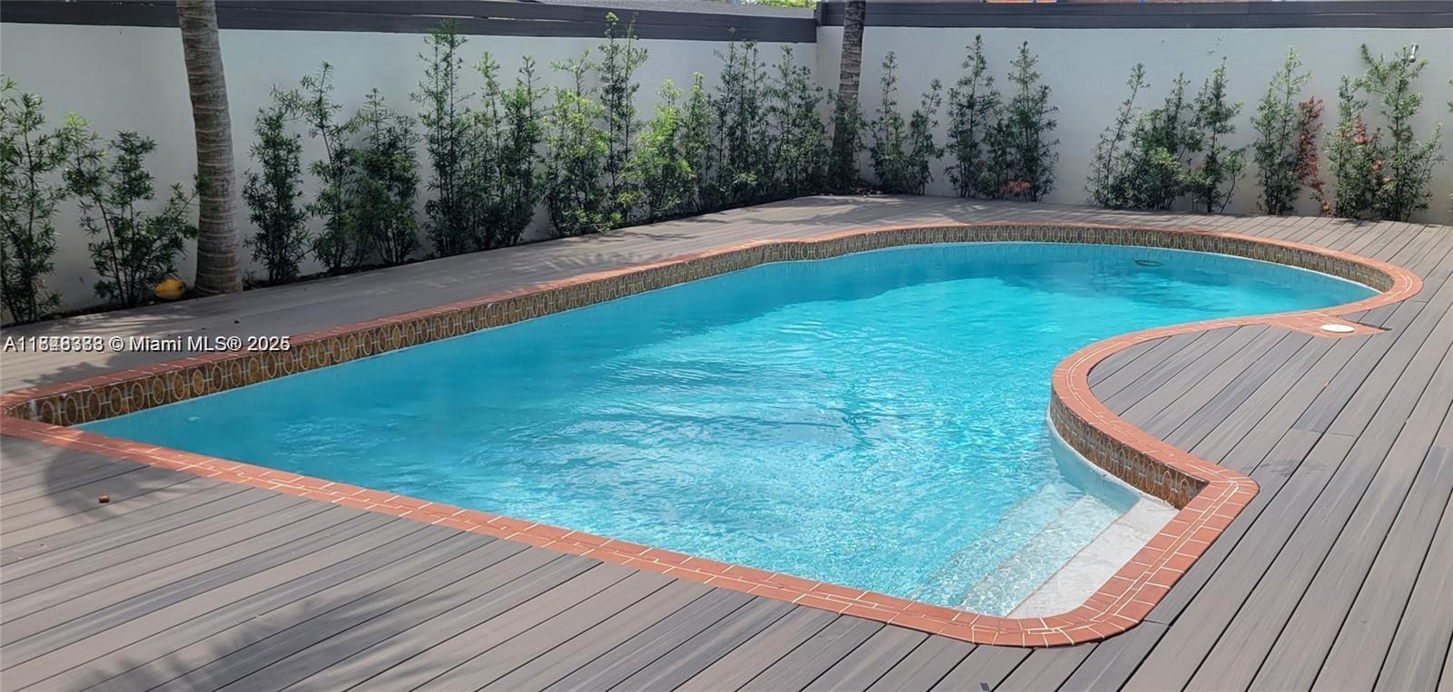 2710 Southwest 31st Avenue Miami, FL 33133 - Photo 9 of 29 a view of a wooden deck with a backyard