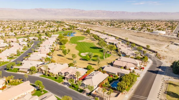 an aerial view of residential houses with outdoor space