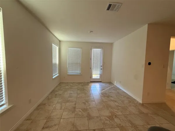 a kitchen with kitchen island granite countertop a stove top oven a sink and a refrigerator