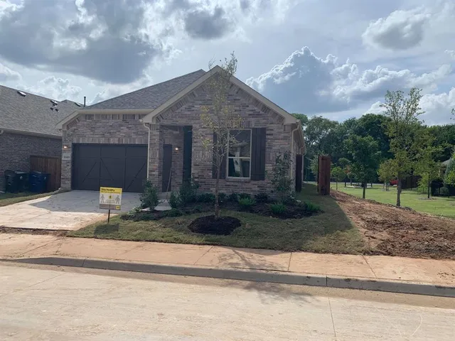 a front view of house with garage and yard