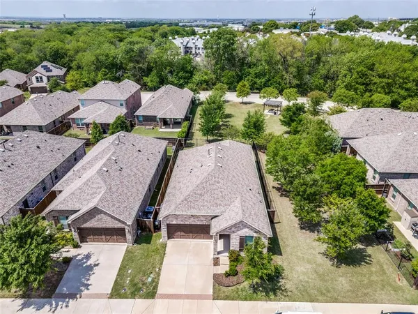 an aerial view of a house with a yard basket ball court and outdoor seating