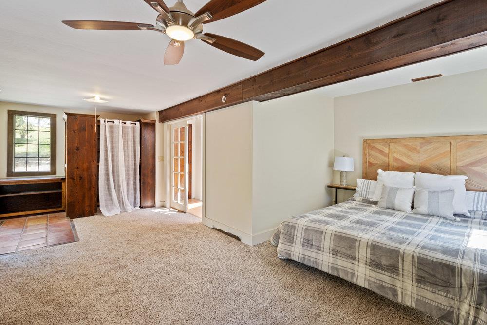 1003 Laurel Glen Road Soquel, CA 95073 - Photo 40 of 115 a bedroom with a large bed and a chandelier