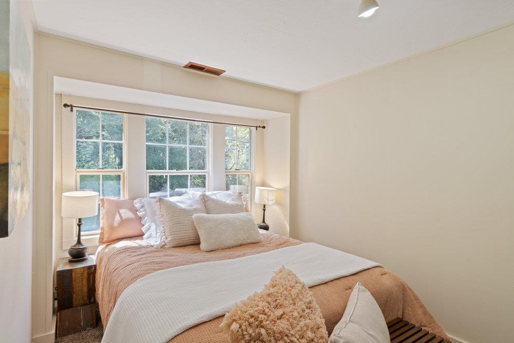1003 Laurel Glen Road Soquel, CA 95073 - Photo 44 of 115 a bedroom with a bed and a large window
