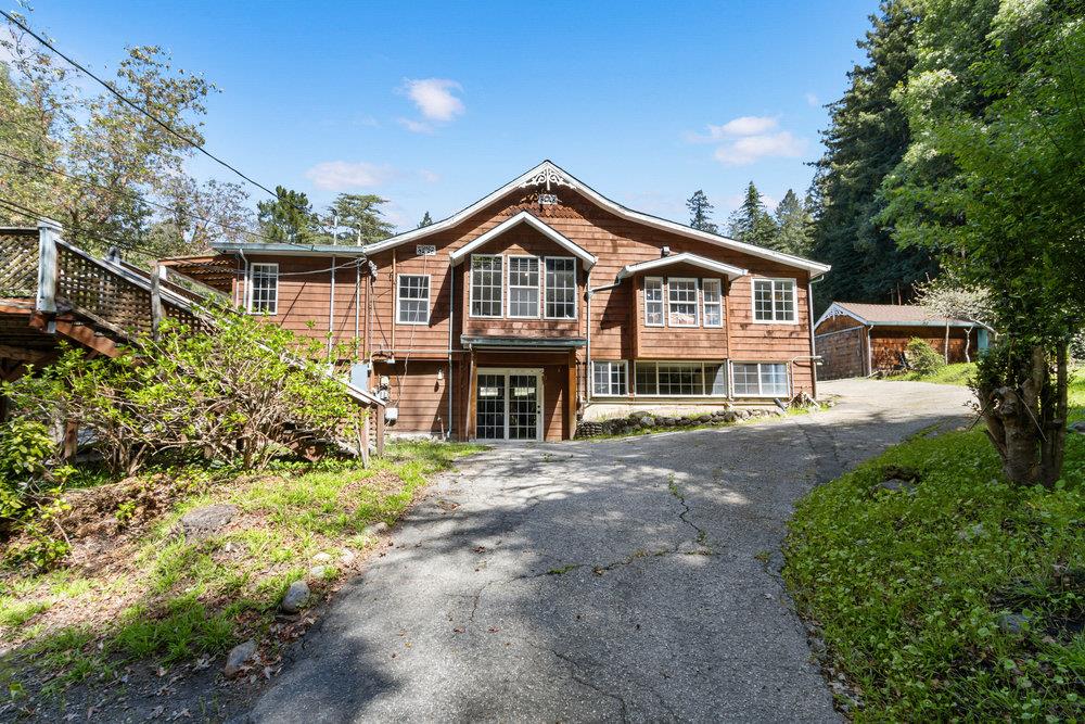 1003 Laurel Glen Road Soquel, CA 95073 - Photo 5 of 115 a front view of a house with a garden and plants