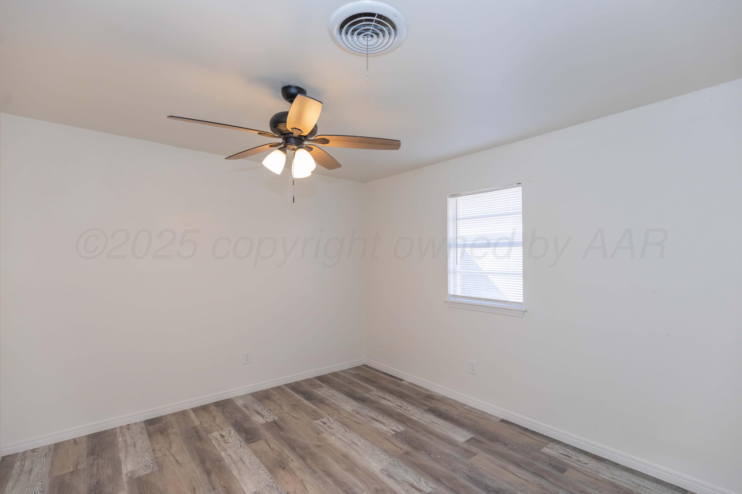 6104 Cornell Street Amarillo, TX 79109 - Photo 26 of 39 an empty room with a window and a fan