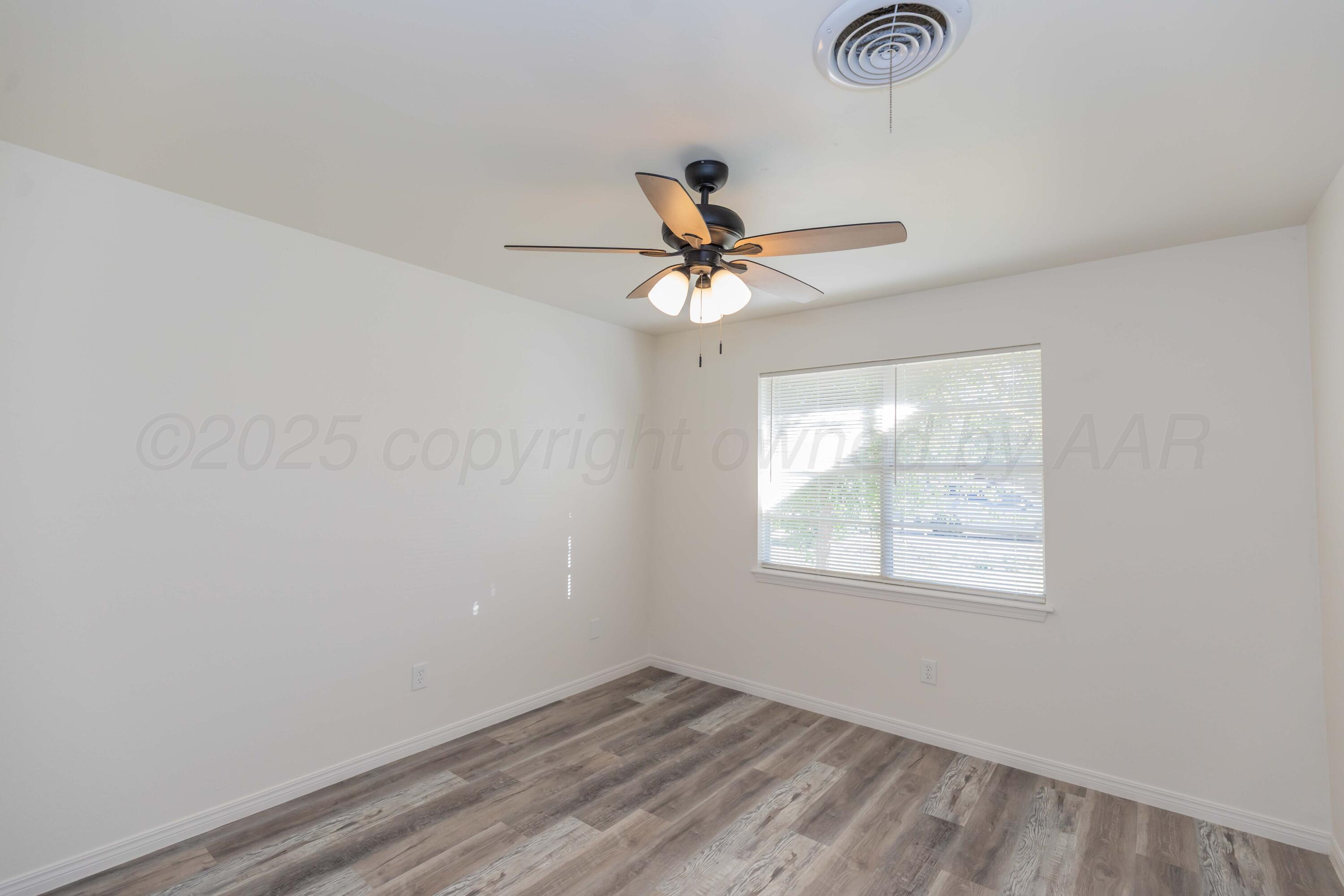 6104 Cornell Street Amarillo, TX 79109 - Photo 31 of 39 an empty room with a window and a fan
