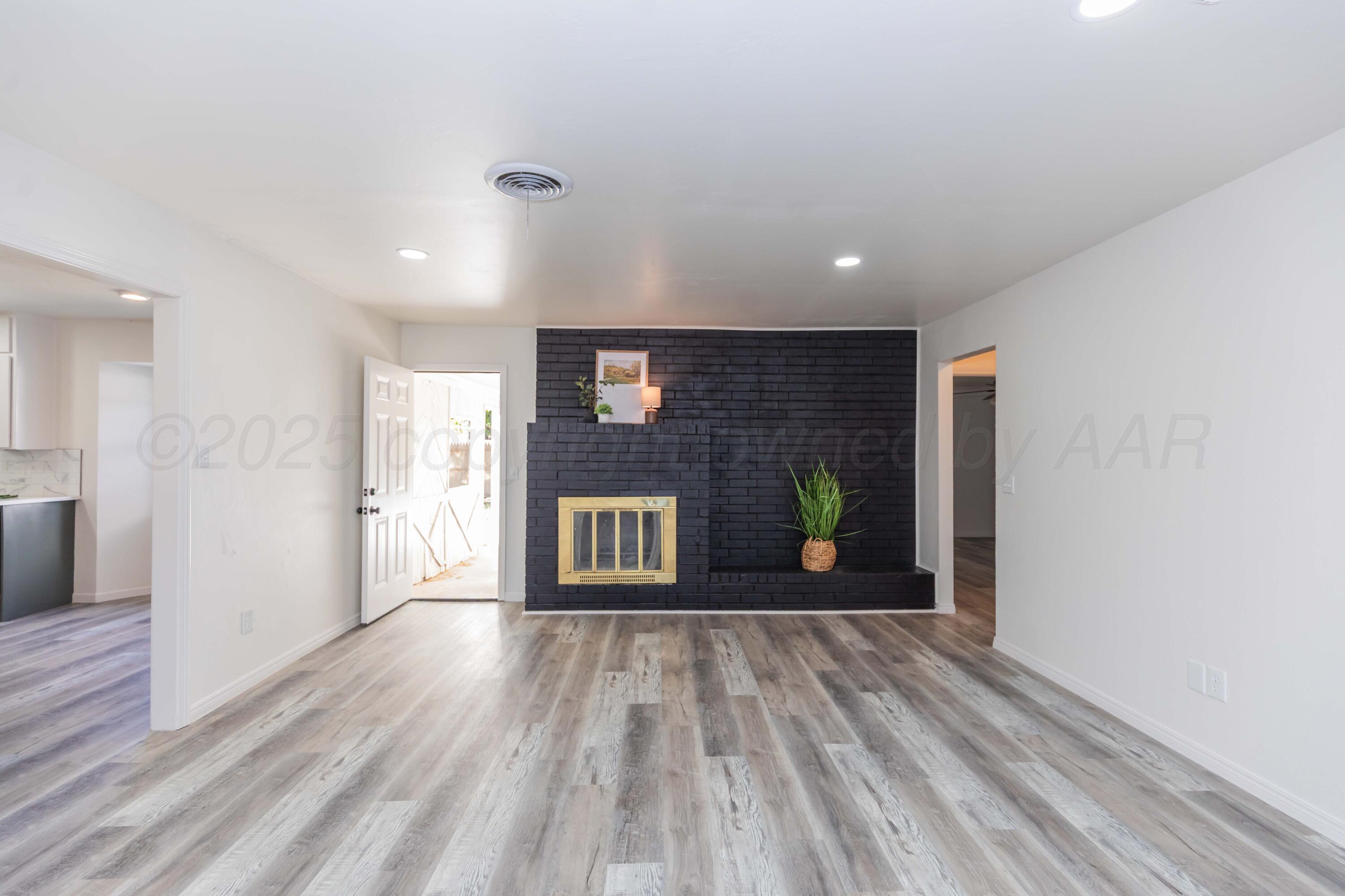 6104 Cornell Street Amarillo, TX 79109 - Photo 5 of 39 a view of a livingroom with wooden floor